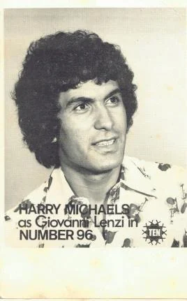 A black-and-white publicity card printed ‘Harry Michaels as Giovanni Lenzi in Number 96’ beside a network logo, showing a young man with dark curly hair in a patterned shirt.